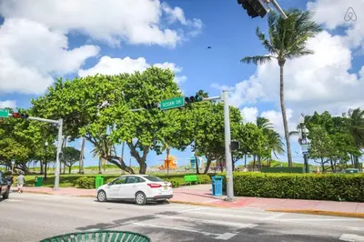 a car parked at an intersection with a street sign at Ocean Drive Studio Roof top Pool and Bar in Miami Beach