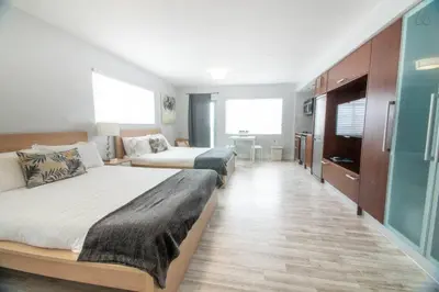 a hotel room with two beds and a television at Ocean Drive Studio Roof top Pool and Bar in Miami Beach