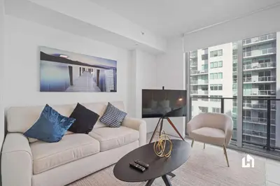 a living room with a couch and a table at Downtown Vibes Pool Gym & Oceanview in Miami