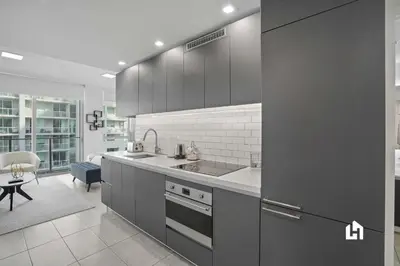 a kitchen with a sink and a stove top oven at Downtown Vibes Pool Gym & Oceanview in Miami