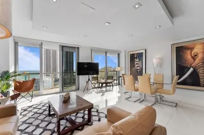 a living room with a couch and a table at Family Oriented Apartments with unbelievable views in Hallandale Beach