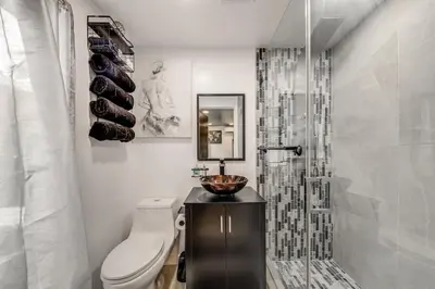 a bathroom with a toilet and a sink and a shower at Mod Bungalow with Ultra-Private Outdoor Hang Space! in Miami Gardens