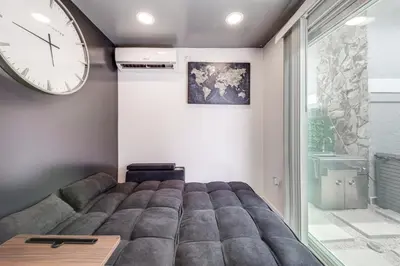 a bedroom with a bed and a large clock on the wall at Mod Bungalow with Ultra-Private Outdoor Hang Space! in Miami Gardens