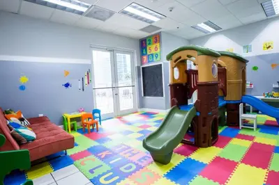 a play room with a slide and a couch at Fantastic APT Brickell in Miami