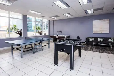 a room with two ping pong tables and a couch at Fantastic APT Brickell in Miami