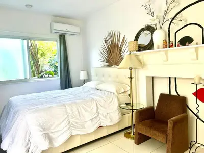 a white bedroom with a bed and a chair at Retreat Independent Entire Room in Princeton