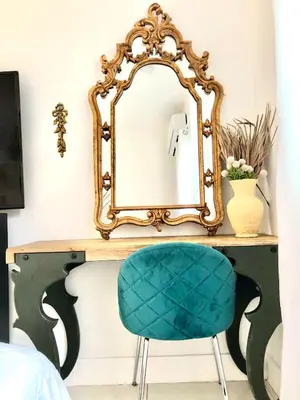 a mirror on top of a desk with a blue chair at Retreat Independent Entire Room in Princeton