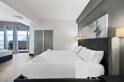 a bedroom with a large white bed with white pillows at Heart of South Beach Balcony Rooftop Pool in Miami Beach