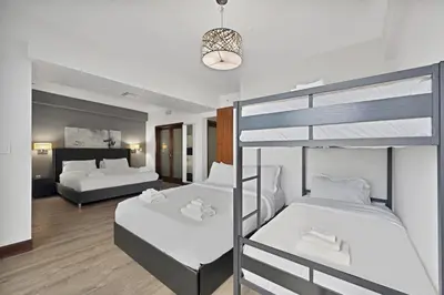 a bedroom with two bunk beds and a living room at Heart of South Beach Balcony Rooftop Pool in Miami Beach