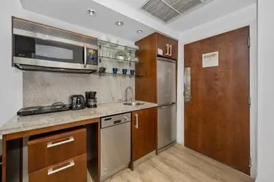 a kitchen with a sink and a microwave at Steps from the Ocean Comfy Studio with King Bed in Miami Beach