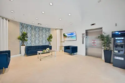 a lobby with a waiting room with blue couches and a table at Stylish Studio in South Beach with Ocean Views in Miami Beach