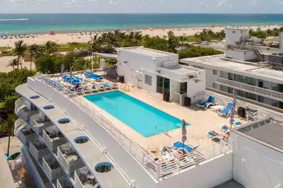 an aerial view of a resort with a pool and the beach at Heart of the Ocean Drive 1BDR Rooftop Pool with cabanas in Miami Beach