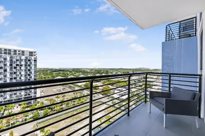 a balcony with a chair and a view at Modern Doral Condo w Free Parking in Miami