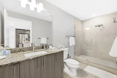a bathroom with a sink and a toilet and a shower at Modern Doral Condo w Free Parking in Miami