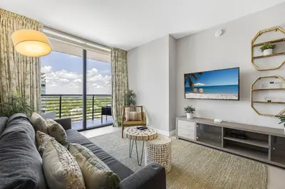 a living room with a couch and a tv at Modern Doral Condo w Free Parking in Miami