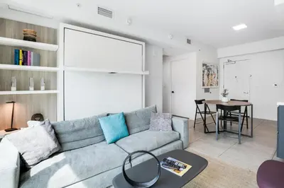 a living room with a couch and a table at Luxury Condo w Rooftop Pool & Gym in Miami