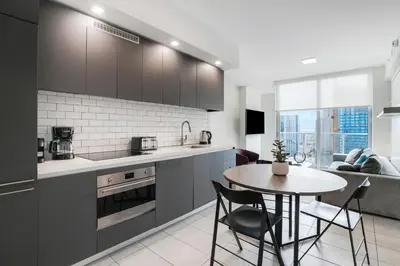 a kitchen with a table and a dining room at Luxury Condo w Rooftop Pool & Gym in Miami