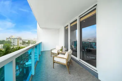 a balcony with two chairs and a view of the city at 2 Bedroom Private Residence at Roney Palace -630 in Miami Beach