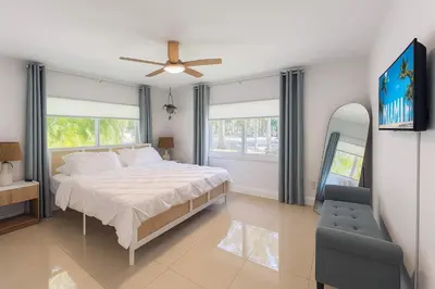 a bedroom with a bed and a ceiling fan at Stylish 2BR Getaway - Prime Miami Location in Miami