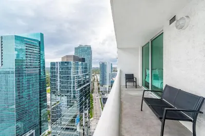 a balcony with a bench and a view of the city at 3 bedroom stunning apt brickell in Miami