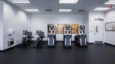 a gym with a row of exercise bikes in it at 3 bedroom stunning apt brickell in Miami