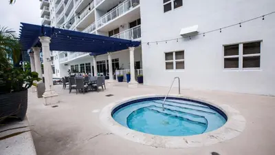 a swimming pool in front of a building at 3 bedroom stunning apt brickell in Miami