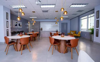 a meeting room with two tables and chairs at 3 bedroom stunning apt brickell in Miami