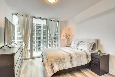 a bedroom with a bed and a large window at Bayside Miami High-Rise Condo By Waterfront Park! in Miami