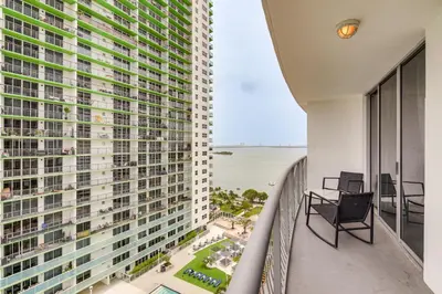 a balcony with two chairs and a view of the ocean at Bayside Miami High-Rise Condo By Waterfront Park! in Miami