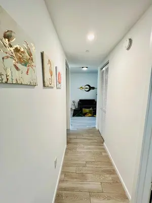 a hallway with white walls and a tile floor at Miami Downtown 2BR Pool-Gym-Views-Great Location in Miami