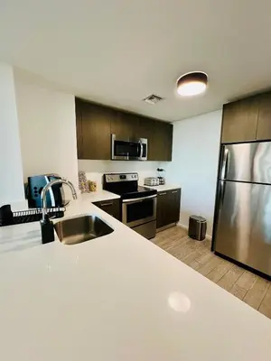a kitchen with a sink and a stainless steel refrigerator at Miami Downtown 2BR Pool-Gym-Views-Great Location in Miami