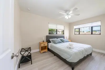 a bedroom with a bed with a ceiling fan at Golden Welcome in Hollywood