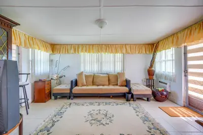 a living room with a couch and a rug at Less Than 3 Mi to Hard Rock Stadium Miami Home with Sunroom in Miami