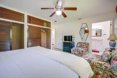 a bedroom with a bed and a couch and a ceiling fan at Less Than 3 Mi to Hard Rock Stadium Miami Home with Sunroom in Miami