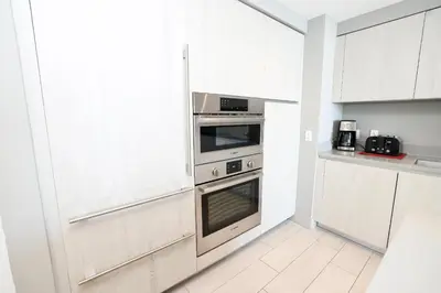 a kitchen with white cabinets and a stainless steel oven at 2 BDR Stunning Ocean View in Hyde Beach House in Hollywood