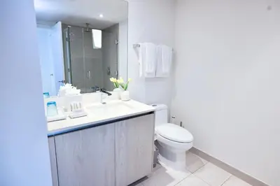 a white bathroom with a sink and a toilet at 2 BDR Stunning Ocean View in Hyde Beach House in Hollywood