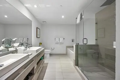 a white bathroom with two sinks and a shower at 2 BDR Penthouse Ocean Front View Hyde Beach House in Hollywood