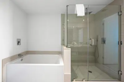 a bathroom with a tub and a glass shower at 2 BDR Penthouse Ocean Front View Hyde Beach House in Hollywood