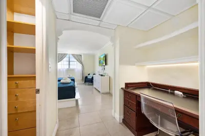a bedroom with a desk and a bed in a room at Bright Stylish 2BR Condo Stunning View Of Ocean in Sunny Isles Beach