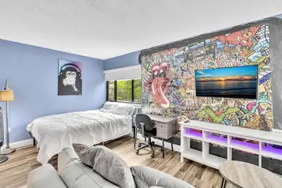 a bedroom with a large mural on the wall at Coconut Grove Haven Family in Miami