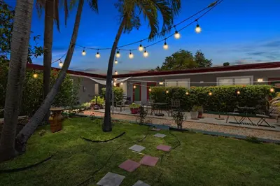 a backyard with string lights and palm trees at 1BR Studio Parking, Pet Friendly and BBQ Area in Hollywood