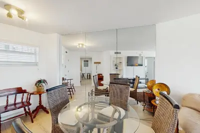 a living room with a glass table and chairs at Miami Lux Haven in Miami Beach