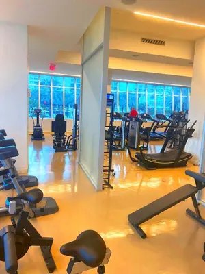 a gym with a lot of exercise equipment in a building at Luxury Condo at Trésor Miami Beach in Miami Beach