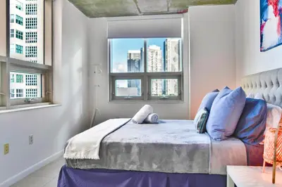 a bedroom with a bed and a window at Miami Midblock Condo - City Views, Pool & Balcony! in Miami