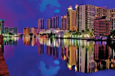 a city skyline at night with its reflection in the water at Tempurpedic Queen - Laundry, Parking & EV Charger in Hollywood