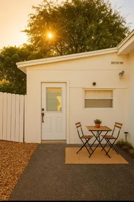 a table and two chairs in front of a garage at Tempurpedic Queen - Laundry, Parking & EV Charger in Hollywood