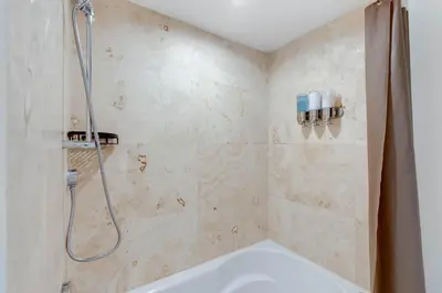 a bathroom with a shower and a tub at Brickell River Views- modern amenities in the city in Miami