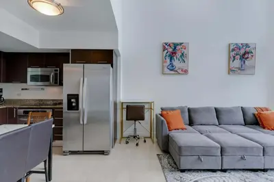 a living room with a couch and a refrigerator at Brickell River Views- modern amenities in the city in Miami