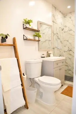 a bathroom with a white toilet and a sink at Vibrant 4bd 2ba Miami Home w POOL in Miami