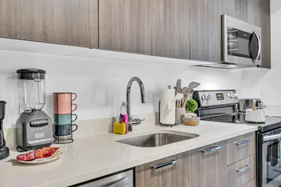 a kitchen counter with a sink and a blender at Modern Studio City Views in Miami